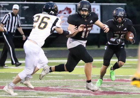 Harlan County running back Thomas Jordan followed a block from Josh Sergent in a district clash Friday against Clay County. Jordan ran for 85 yards in the Bears 42-20 loss.