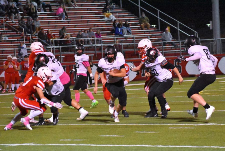 Harlan County quarterback Jonah Swanner followed blocks by Issac Downs, Connor Blevins, Johnny Brock and Austin Roark on a touchdown run Friday at Perry Central.