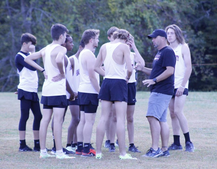 Harlan County coach Ryan Vitatoe talked to his team during a race earlier this season. Both HCHS and Harlan will compete in regional meets Saturday at Wayne County High School.