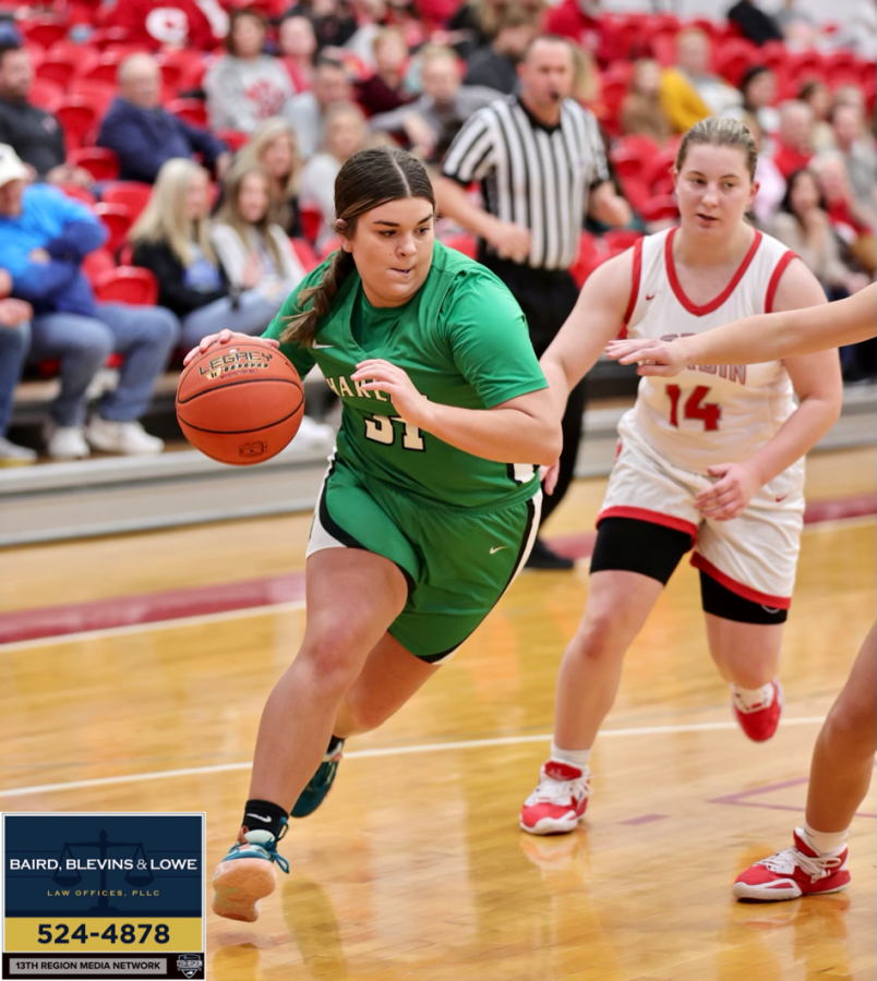 Harlan sophomore forward Leah Davis drove to the basket in the Lady Dragons season-opening game Tuesday at Corbin. The Lady Hounds claimed a 62-33 victory.