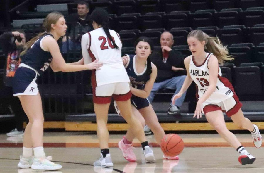 Harlan County senior Taytum Griffin followed a pick from Jaylin Smith on her way to the basket in Mondays season-opening game against Knott Central. Griffin scored 15 points in the Lady Bears 65-57 victory.