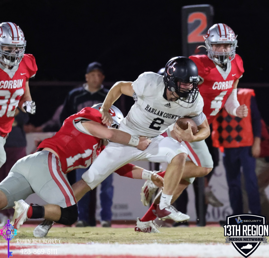 Harlan+County+quarterback%2Freceiver+Jonah+Swanner+battled+for+yardage+in+playoff+action+Friday+at+Corbin.+The+Redhounds+advanced+with+a+55-0+victory.