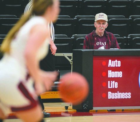 Bill Ellis watched from the press table at Harlan County High School during a basketball game several years ago. Ellis, who died on Friday, was a radio broadcaster and coach in Harlan County for many years and was well-known across the region.
