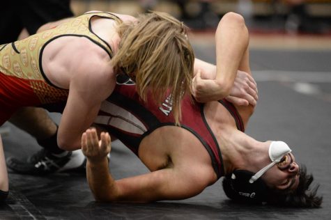 Harlan County senior Nathaniel Gross battled to break free from a Lee, Va., wrestler on Wednesday in a four-team match at Harlan County High School. It was the first meet held at HCHS, which started a wrestling program last year. The Black Bears defeated Knott Central and Lee before falling to Bell County.