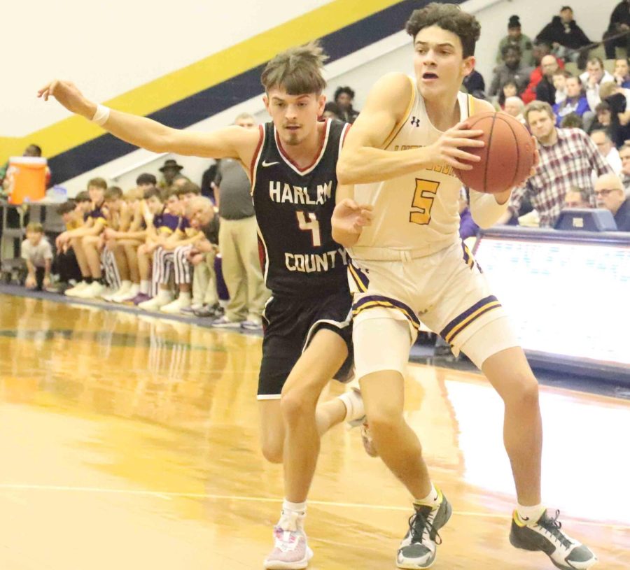 Harlan County guard Daniel Carmical pursued Lyon Countys Jack Reddick on Saturday in the King of the Bluegrass tournament. Carmical scored 21 points in the Bears 76-73 loss.