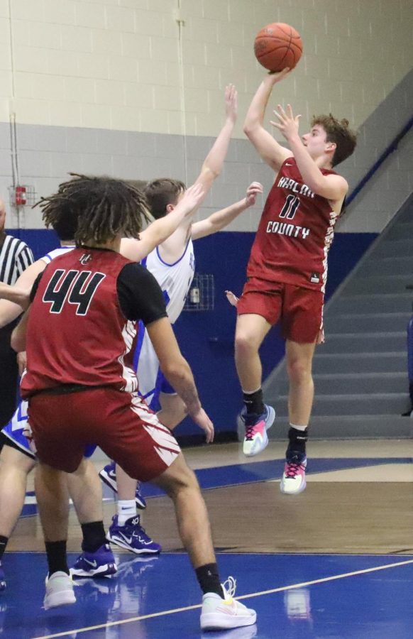 Harlan County sophomore guard Ethan Simpson lofted a shot over a Bell County defender for two of his eight points in the Black Bears 52-41 victory.