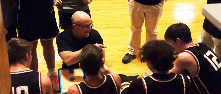 Harlan County coach Kyle Jones talked with his team during a break in the action at the King of the Bluegrass tournament on Sunday. The Bears evened their record at the tournament with a 69-46 win over tournament host Fairdale.