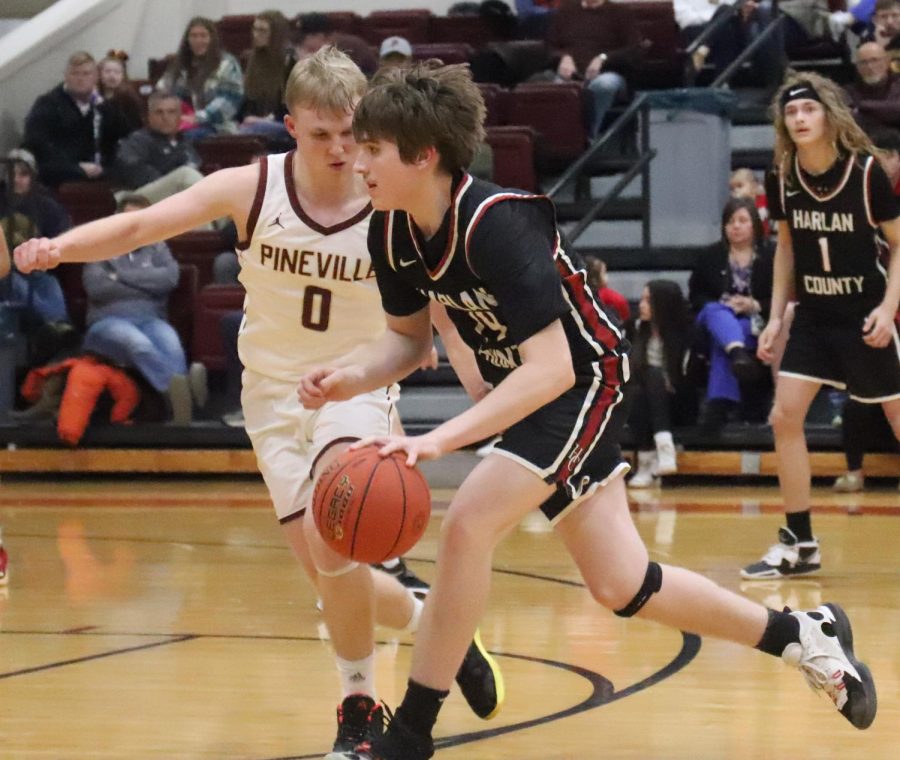 Harlan County guard Brody Napier worked against Pinevilles Sawyer Thompson on Tuesday. Thompson scored 24 points to lead the Lions in a 94-71 loss.