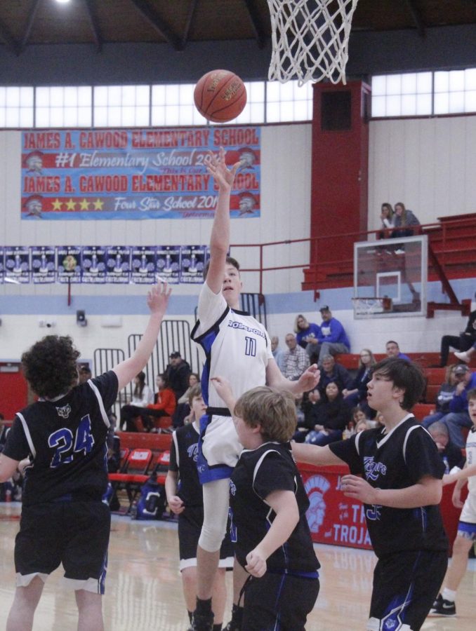 Rosspoints+Gunnar+Johnson+was+surrounded+by+defenders+as+he+put+up+a+shot+in+action+from+the+seventh-+and+eighth-grade+county+tournament.