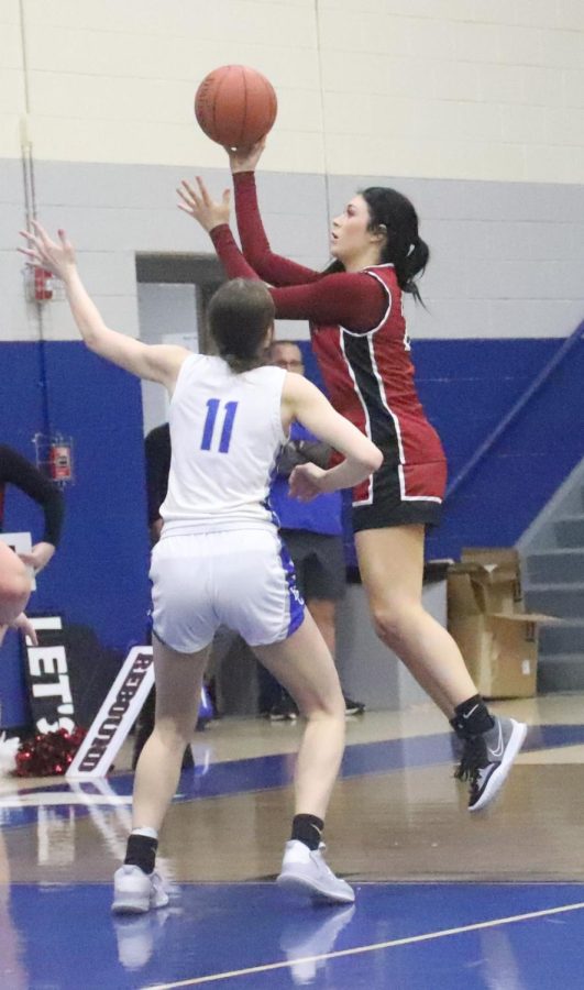 Harlan County forward Jaylin Smith put up a shot over Bell Countys Gracie Jo WIlder in Tuesdays district game. Wilder scored 39 points in the Lady Cats 67-56 win. Smith scored 16 for the Lady Bears.