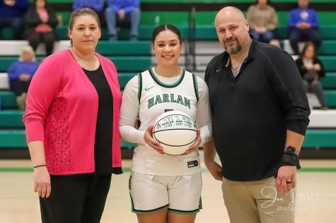 Harlans Kylie Noe was honored for recently scoring her 1,000th point in her high school career. She joined Harlans 1,000-point club with her 21-point effort against Letcher Central on Tuesday. She is pictured with Harlan coach Tiffany Hamm Rowe and Harlan HIgh School Principal Britt Lawson.