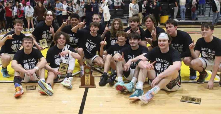 The Harlan County Black Bears are pictured with their trophy after defeating Harlan 72-62 to capture the 52nd District Tournament title. It was the Bears eighth district title in the 15-year history of the school.