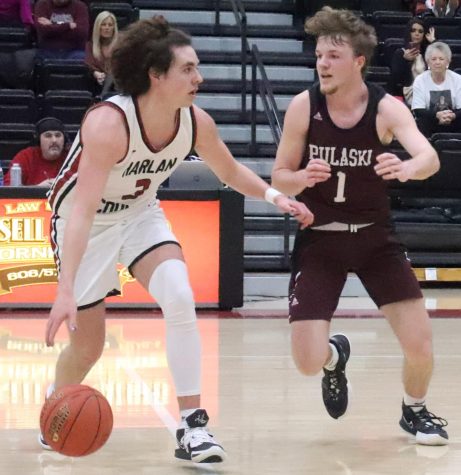 Harlan County guard Maddox Huff worked around Pulaski Countys Bryson Dugger in Fridays game at HCHS. Huff had 17 points and 10 rebounds in the Bears 76-71 win in a matchup of two teams ranked in the states top 20.