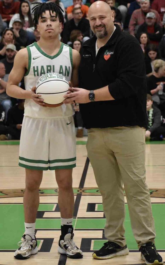Harlan+junior+guard+Kyler+McLendon+recently+became+the+third+member+of+the+current+team+to+join+the+schools+1%2C000-point+club.+McLendon+was+presented+a+basketball+by+Harlan+High+School+Principal+Britt+Lawson.