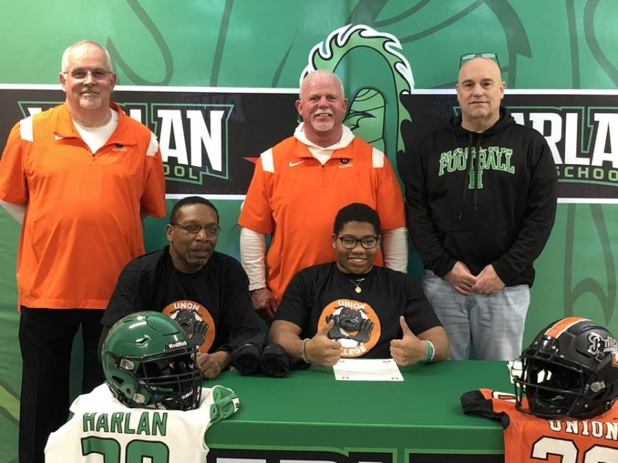 Harlan linebacker R.W. Sanford signed Wednesday to continue his football career at Union College. Sanford is pictured with his farther, Robert Sanford Jr., along with Union coaches J.B. Donahue and John Luttrell and Harlan coach Eric Perry,.