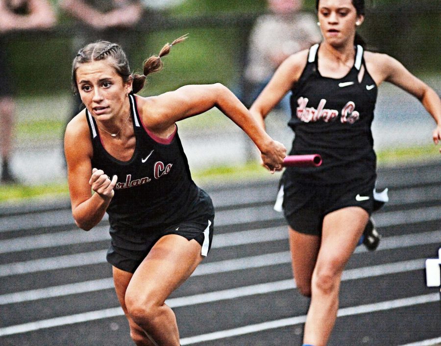 Harlan+Countys+Ella+Karst+took+the+baton+during+a+relay+race+Friday+at+Coal+Miners+Memorial+Stadium.+Karst+set+a+school+record+in+the+100-meter+run+and+also+won+the+200-meter+race.