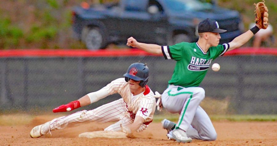 Harlan Countys Jonah Swanner slid into third base as Harlans Jake Brewer attempted to scoop the throw. The Bears claimed a 9-8 win in 12 innings for their fifth-straight victory.