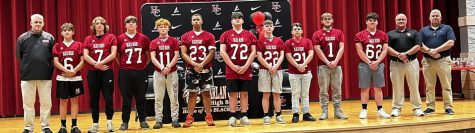 The Harlan County High School football program welcomed next year’s freshman class in a ceremony at the high school. Those participating included, from left: coach Pete Dean, Colby Shepherd, Jacob Sage, Cooper Blevins, Isaiah Cornett, Shemar Carr, Lee Senters, Ashton Anderson, Rhylend Thomas, Matthew Hubbard, Zach Music, coach Amos McCreary and coach Jeff Beach.