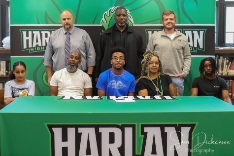 Harlan senior forward Jaedyn Gist signed with Berea College earlier this week to continue his academic and basketball careers. Pictured with Gist are, from left, front row: Talae Taylor, James Gist, Gist, Mary Wilson and Sedrick Washington; back row: Harlan High School Principal Britt Lawson, Harlan coach Derrick Akal and Harlan assistant coach Jeremy Williams.