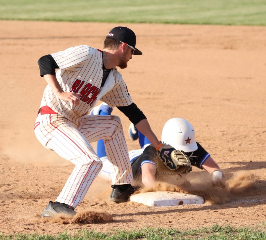 Harlan County first baseman Brayden Blakley tagged Bell Countys Alex Creech as he made his way back to the bag in Mondays district game. Blakley had two hits and reached base all four times he came to the plate in the Bears 12-4 victory.