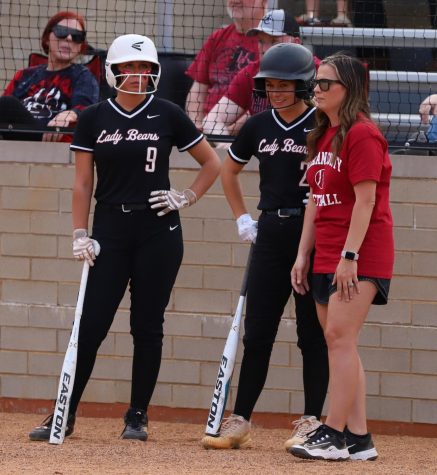 Harlan County coach Shelby Burton talked to Hailey Austin and Madison Blair during a game earlier this season. Austin had three hits Friday and Blair pitched a complete game as the Lady Bears edged Whitley County 11-9.