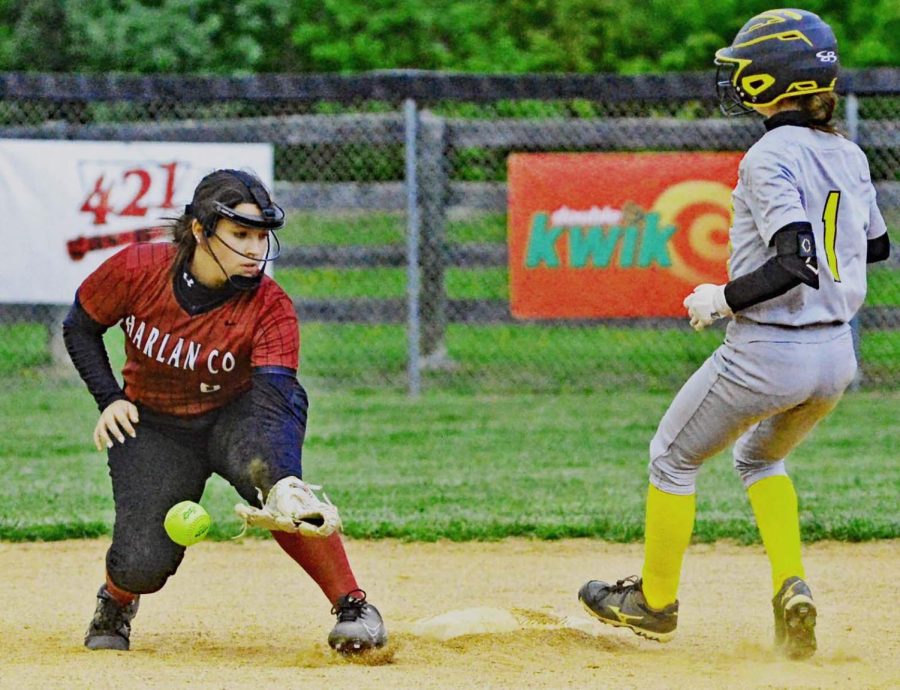 Harlan Countys Jenna WIlson knocked down a throw as Middlesboros Kylee Lawson took second in Tuesdays district clash. The Lady Bears scored six runs in the seventh inning to rally for an 8-7 win.