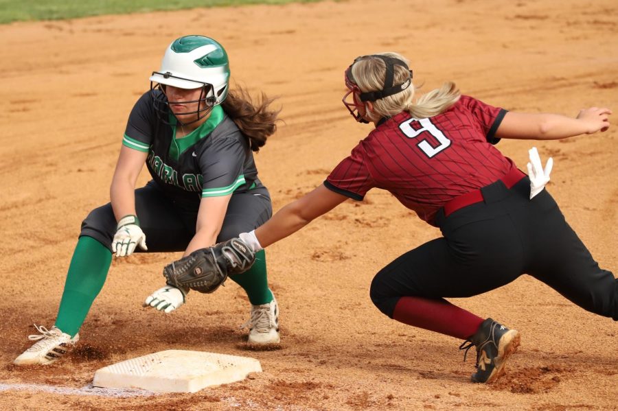 Harlans Ava Nunez was tagged out by Harlan County third baseman Hailey Austin as she tried to advance on one of her three hits Tuesday. Harlan County rallied for a 7-6 victory after falling behind 5-1.