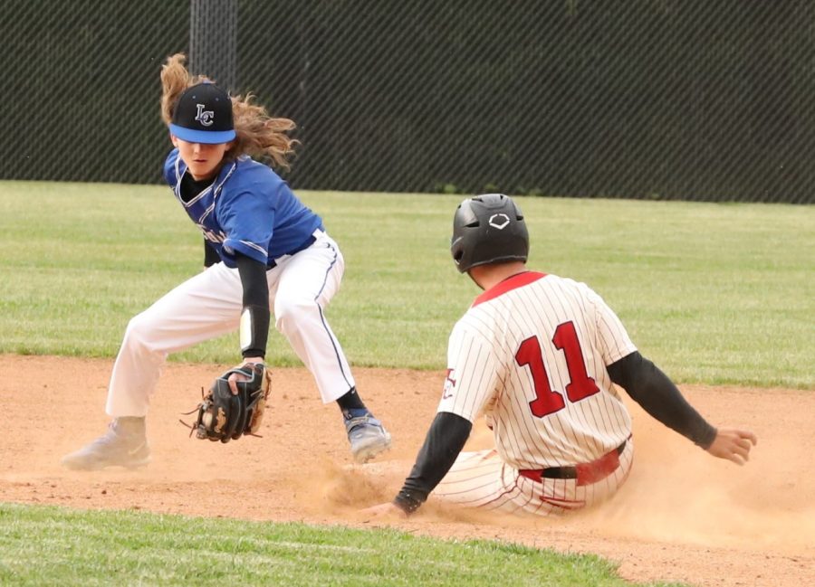 Letcher Central second baseman Mason Boggs took a throw as Isaac Kelly stole second in Mondays game. The visiting Cougars coasted to a 12-0 win.