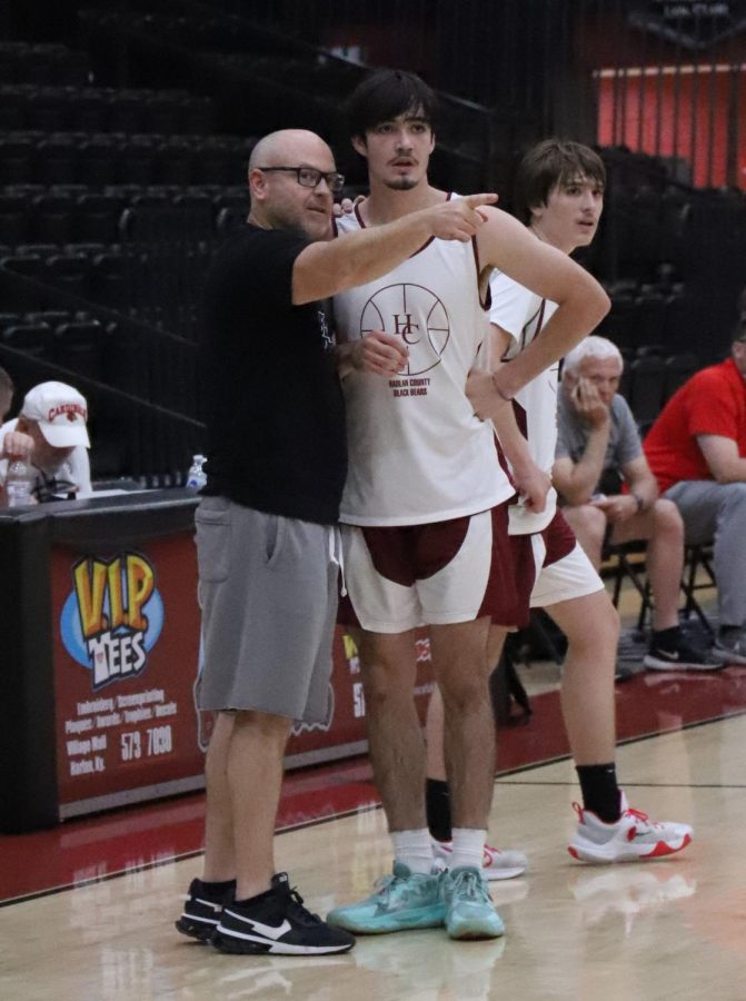 Harlan County coach Kyle Jones talked to senior forward Caleb Johnson in action earlier this summer. Johnson scored 11 points Friday in a win over Whitley County and added 16 in a victory over Perry Central.