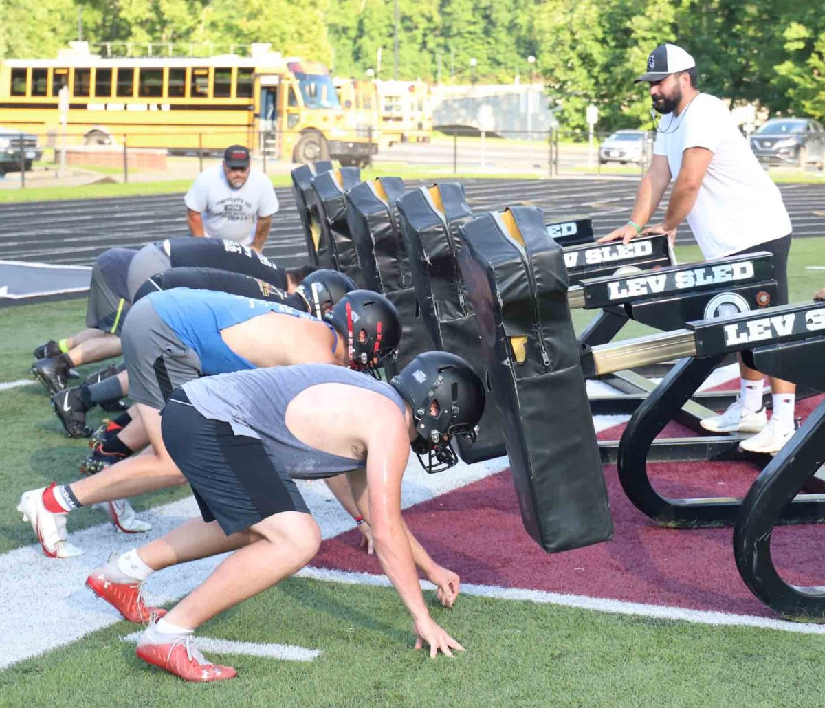 Harlan County assistant coach Scotty Bailey led a sled drill during a recent practice session. Harlan County will open its season Aug. 19 at Middlesboro.