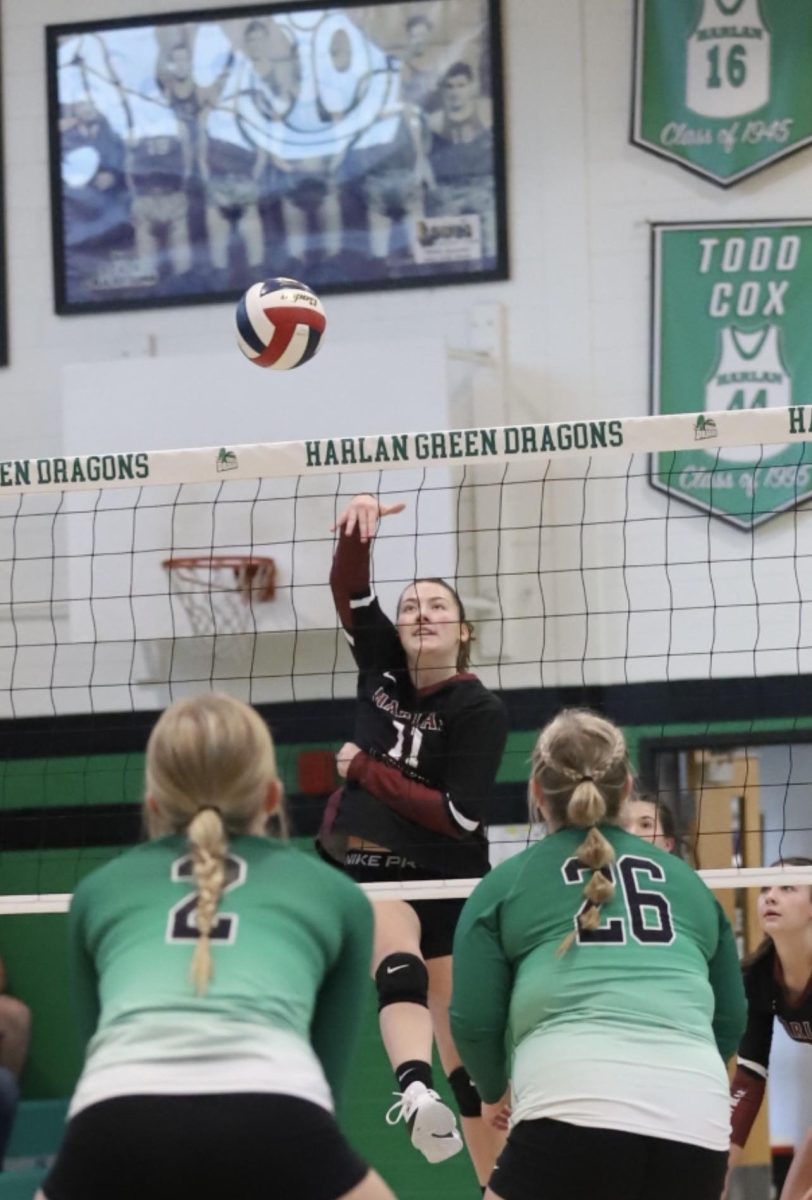 Harlan County sophomore Kylee Hoiska sent the ball back over the net against Harlans Mallory McNiel and Taylor Hall in district action Thursday. The Lady Bears won 25-10, 25-14, 25-8.