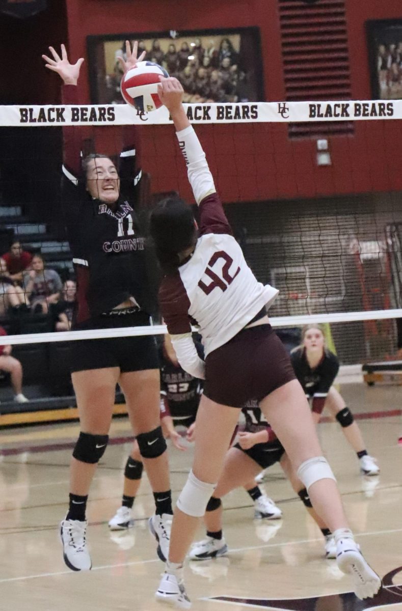 Harlan Countys Kylee Hoiska recorded a block in the Lady Bears season-opening match against Leslie County. The Lady Bears won in three sets.