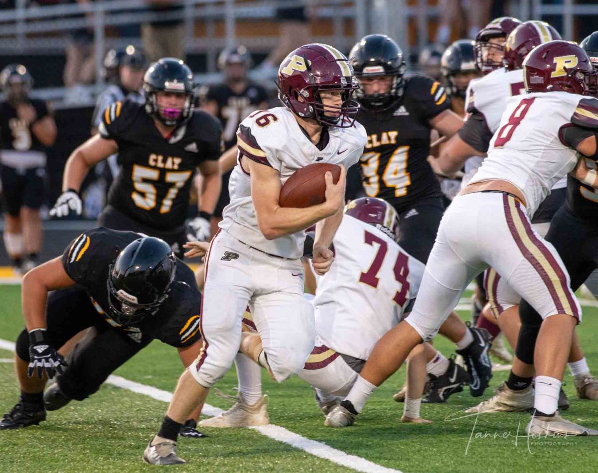 Pineville running back Landon Robbins worked his way around end in the season opener Friday at Clay County. Robbins scored a touchdown in the Lions 58-34 loss.