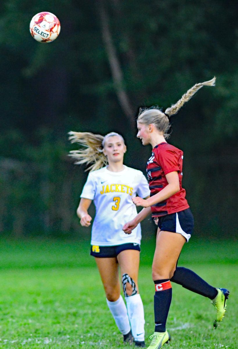 Harlan Countys Victoria Day connected on a header as Middlesboros Addyson Larew moved in during district action Thursday. The visiting Lady Jackets won 4-0.