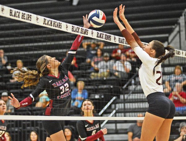 Harlan Countys Destiny Cornett and Pinevilles Ava Arnett battled at the net in 13th Region volleyball action Monday at HCHS. The Lady Bears extended their win streak to three with a three-set victory.