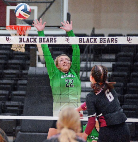 Harlan Countys Kalista Dunn hit the ball over the outstretched arms of Harlans Annie Hoskins in Tuesdays district clash. The Lady Bears won in three sets to improve to 13-6 on the season.