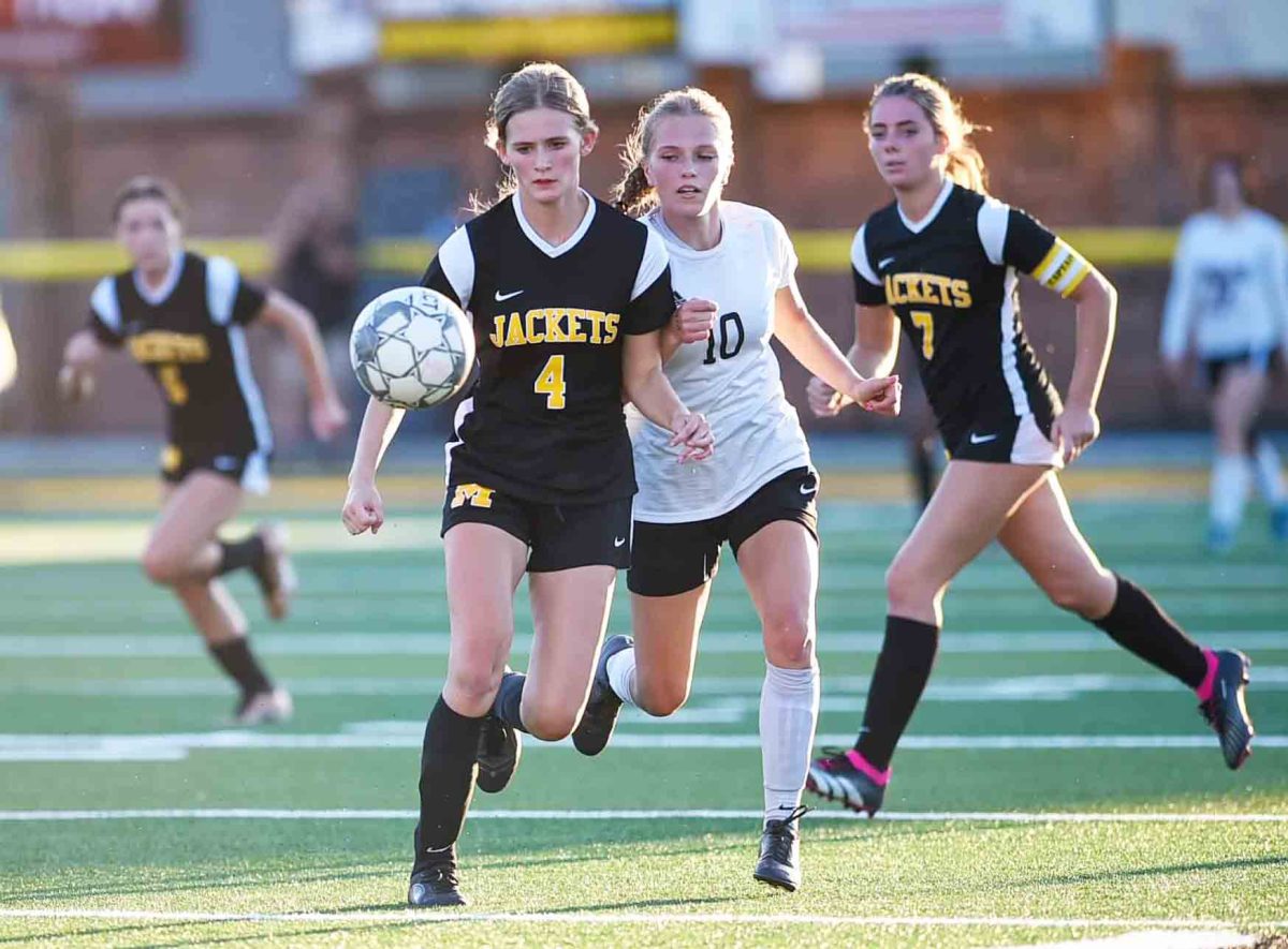 Middlesboros Trinity Partin and Harlan Countys Holly Wright went after the ball in district soccer action Tuesday. The Lady Jackets won 4-0. No statistics were available at press time.