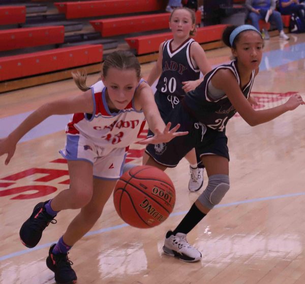 Cawood guard Addy Cochran chased down a loose ball as Cumberlands Torrie Sundy defended in action from the fifth- and sixth-grade county tournament.