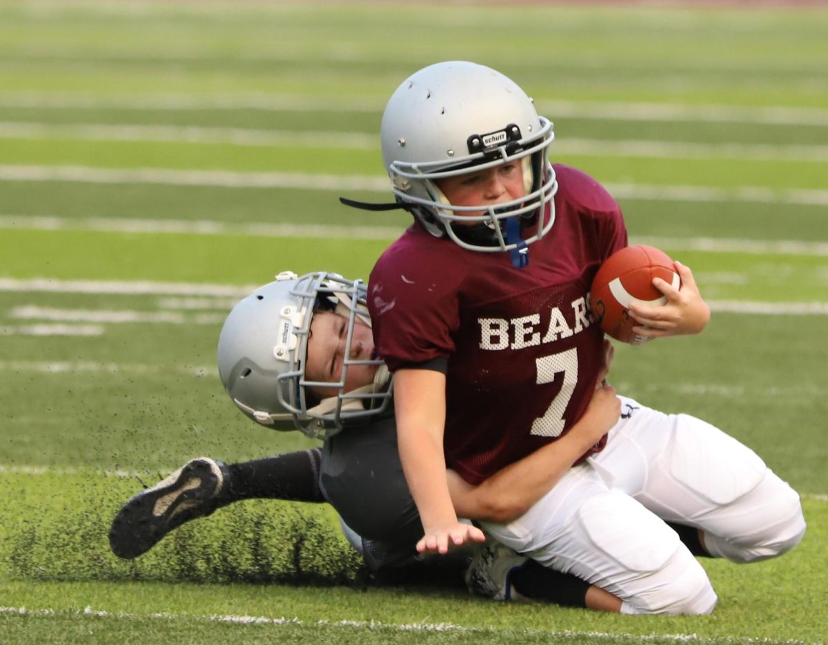Benjamin Toll, of the Silver Bears, brought down Tyson Surber, of the Maroon Bears, during action Thursday in the Harlan County Pee Wee Football League.