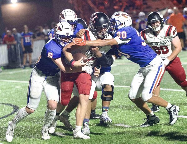 Harlan County quarterback Ethan Rhymer was surrounded by Southwestern defenders in Fridays game in Somerset. The Warriors rolled to a 49-12 victory as HCHS fell to 0-6.