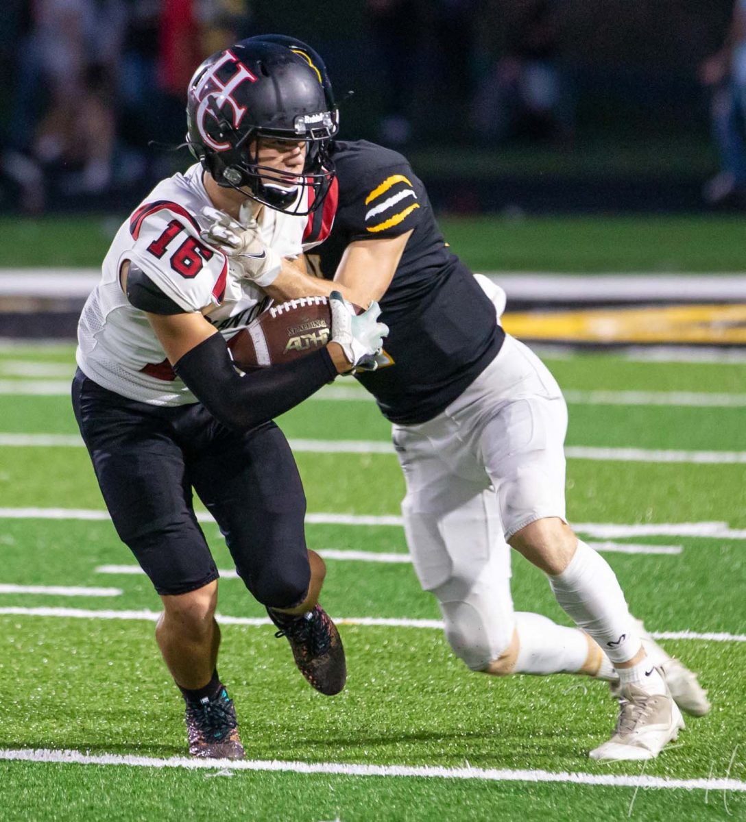 Harlan County receiver Luke Kelly ran after a catch in Fridays game at Clay County. The Tigers pulled away in the second half for a 36-16 win.