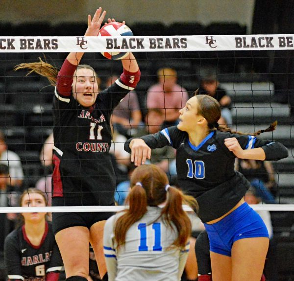 Bell County senior Gracie Jo Wilder went up for one of her kills as Harlan County’s Kylee Hoiska defended in action from the 52nd District Tournament finals Tuesday. Hoiska played a big role in the Lady Bears’ winning the second and third sets, but Wilder led Bell to a comeback five-set victory. Both teams will play in the 13th Region Tournament opening Saturday at Lynn Camp High School.