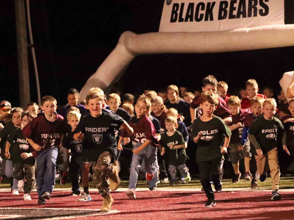 Players in the Harlan County Pee Wee Football League raced through the Black Bears helmet and on to the field at Coal Miners Memorial Stadium before Fridays game against PulaskI County.
