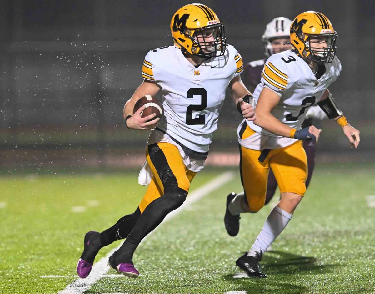 Middlesboro+quarterback+Cayden+Grigsby+followed+running+back+Rylee+Foster+in+Friday%E2%80%99s+playoff+game+at+Pikeville.+Grigsby+ran+for+165+yards+and+threw+for+155+in+the+Jackets%E2%80%99+34-14+loss.