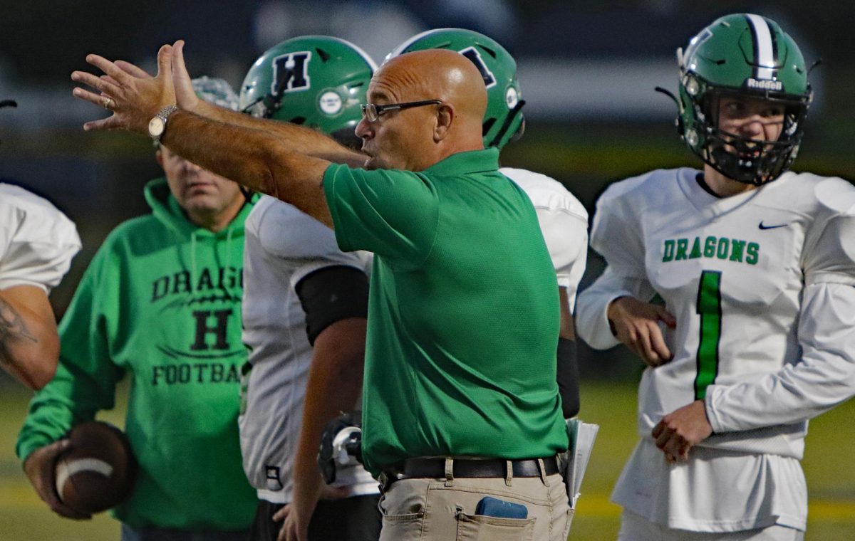 Eric Perry talked with his team during a break in the action in a win last season over Lexington Sayre. Perry stepped down this week as coach of the Green Dragons after five seasons.