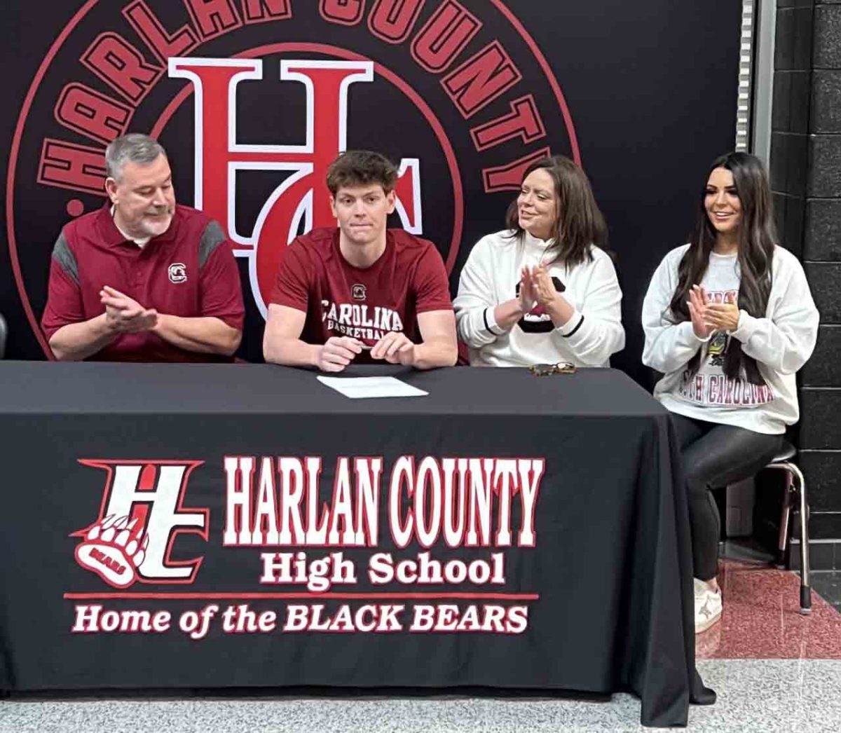 Harlan County High School senior guard Trent Noah signed with the University of South Carolina on Friday at HCHS. Pictured with Noah are his father, Trent; mother, Stacy; and sister, Emersyn.