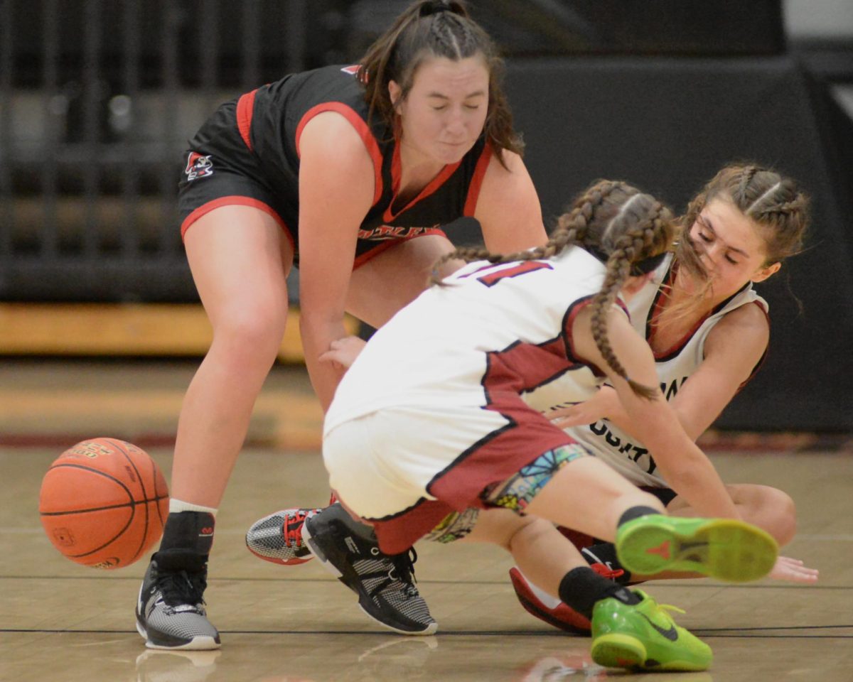 Harlan Countys Reagan Clem and Ella Karst went after a loose ball in Tuesdays game against Whitley County.