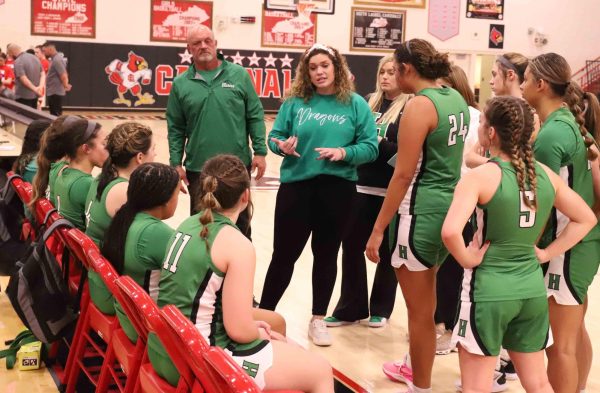 Mackenzie King Varner talked with her team during a timeout in her debut as coach of the Harlan Lady Dragons on Saturday against Wayne County. The Lady Dragons fell 63-60.
