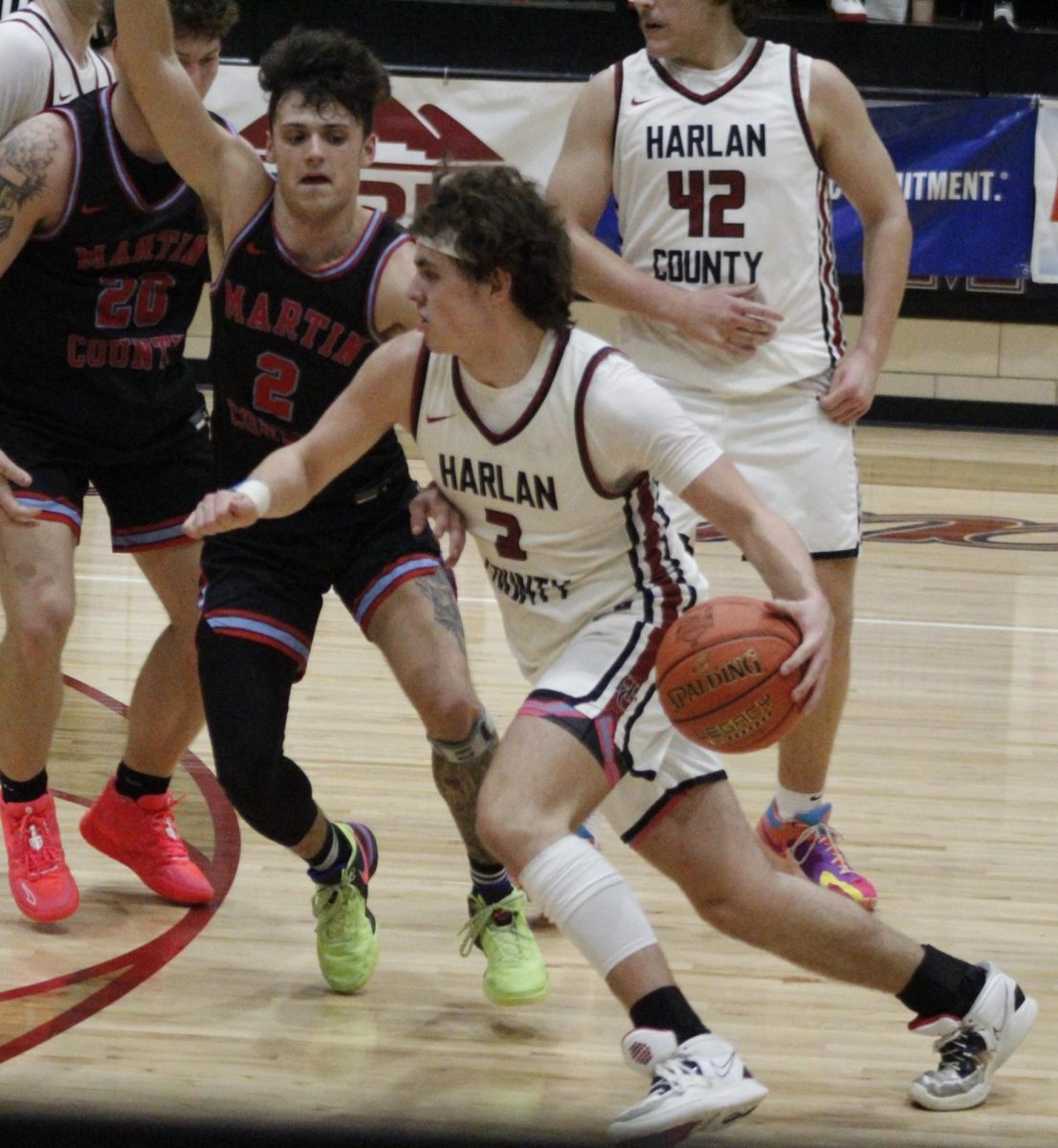 Harlan County junior guard Maddox Huff drove around Martin Countys Luke Hale in action from the WYMT Mountain Classic on Friday. The Bears advanced with an 86-76 victory and will play Perry Central on Saturday in the tournament finals.