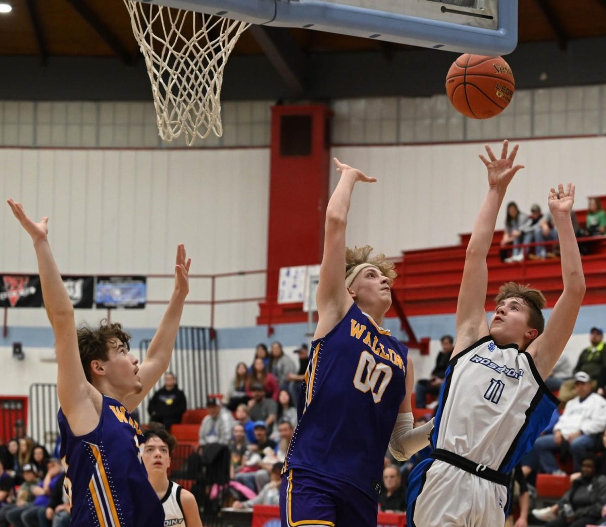 Rosspoint forward Hudson Faulkner put up a shot over Wallins Ryan Day in county tournament action Friday.